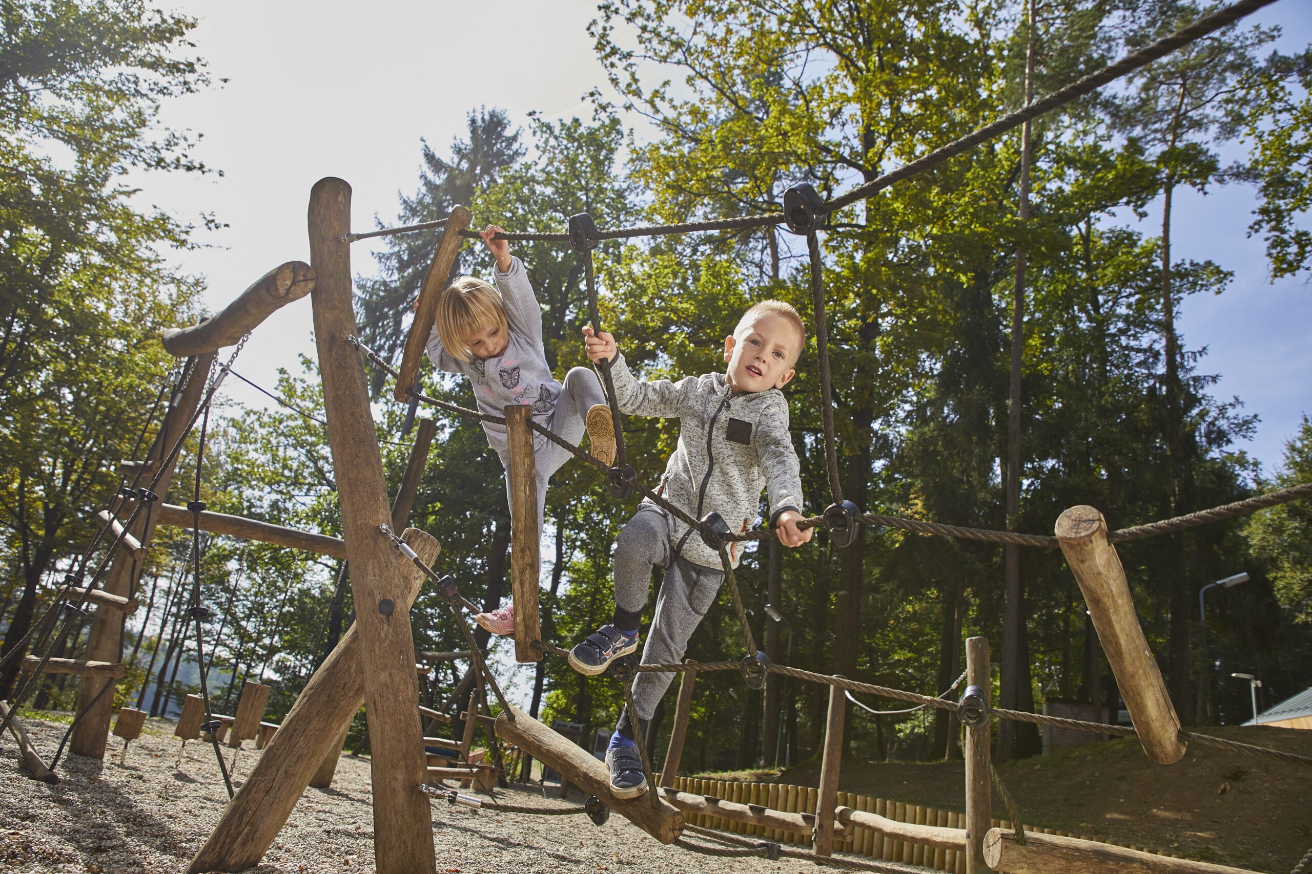 twee blije kinderen spelen in een klimrek